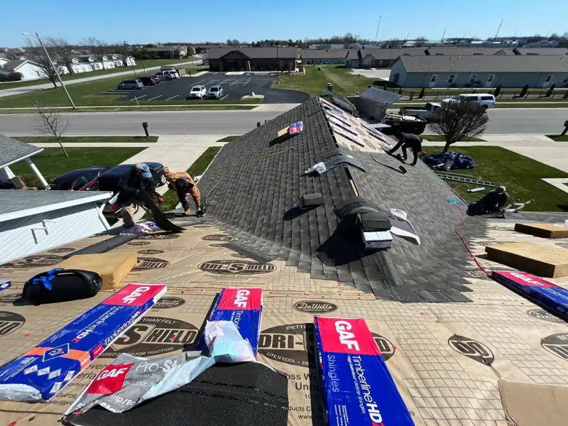 Nitro Roofing crew installing new architectural shingles on an Ohio home